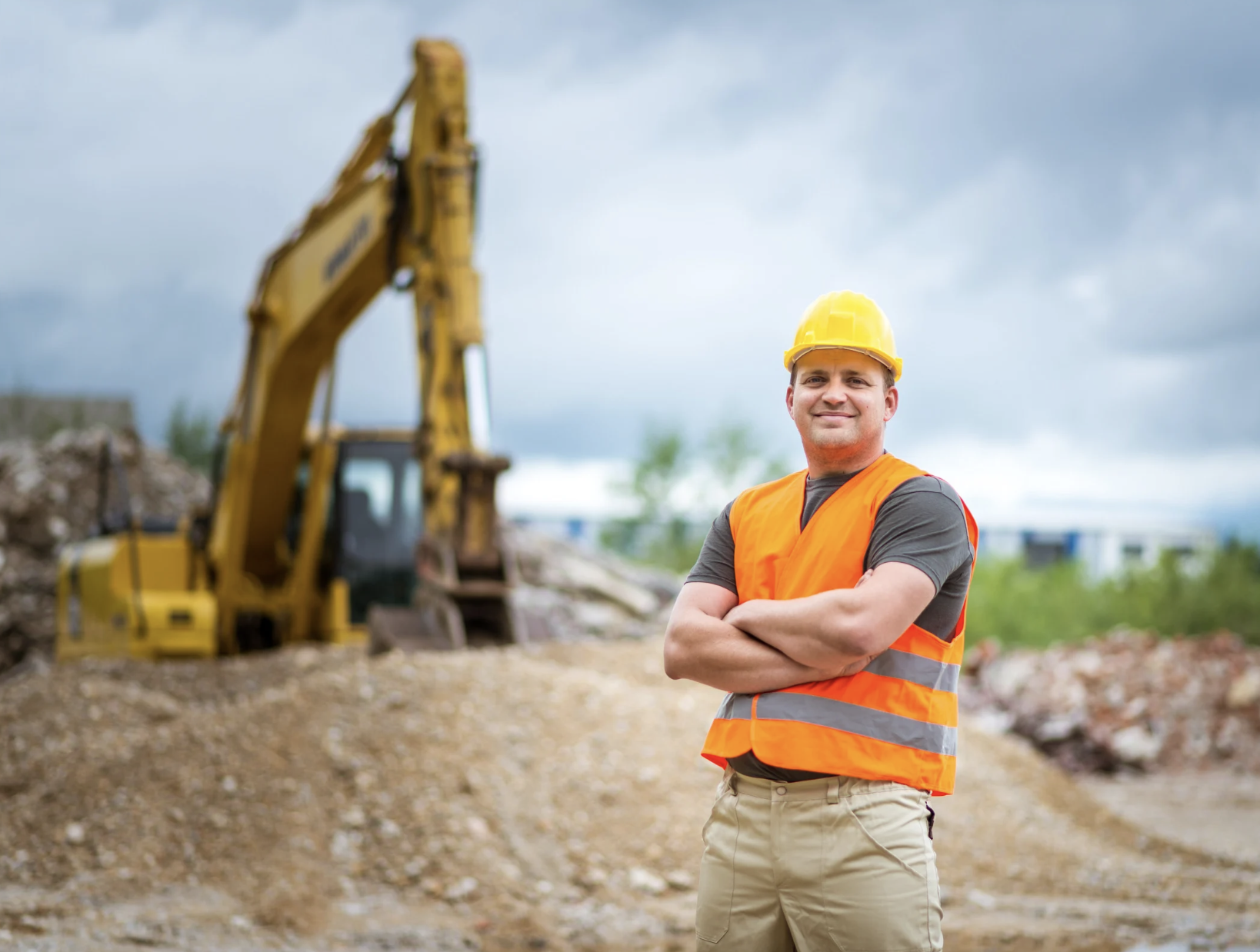 Construction worker on jobsite with hard hat and safety equipment