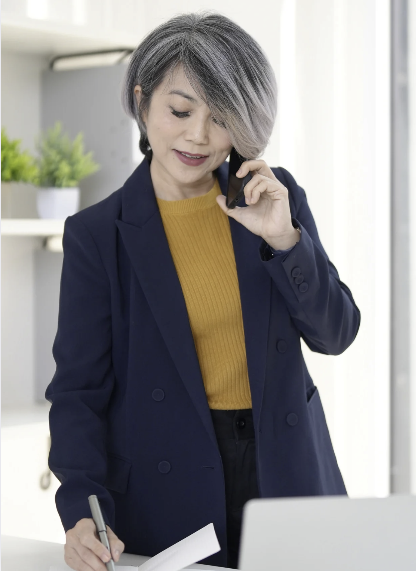 Professional businesswoman with phone and laptop